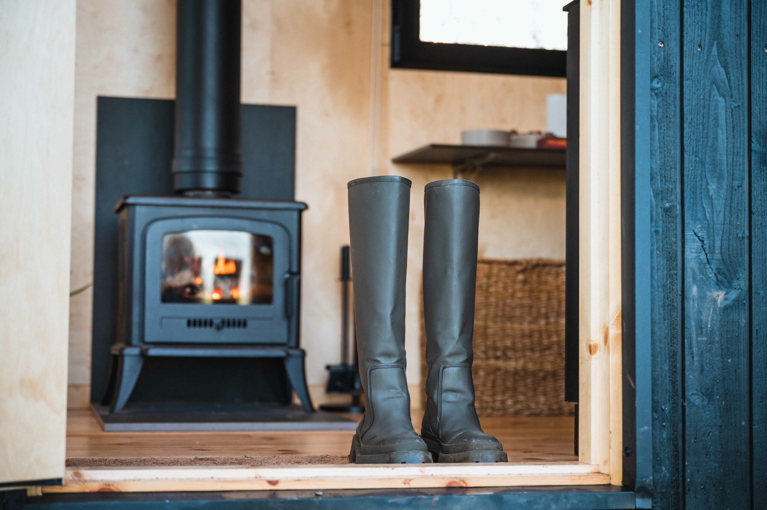 wellies next to a wood stove